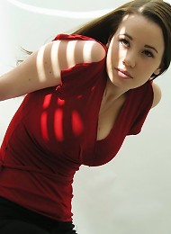 Steph poses in her red top in a studio